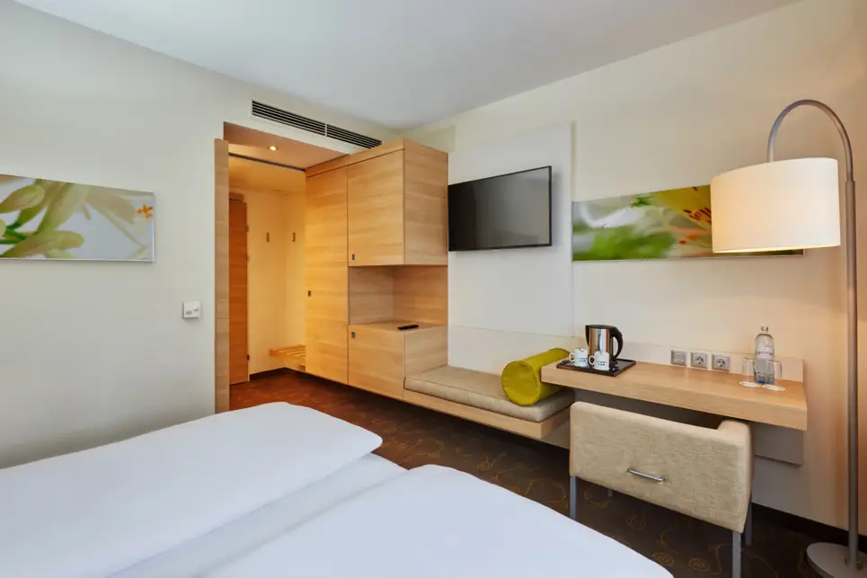 A modern hotel room at the H+ Hotel Salzburg - Official website